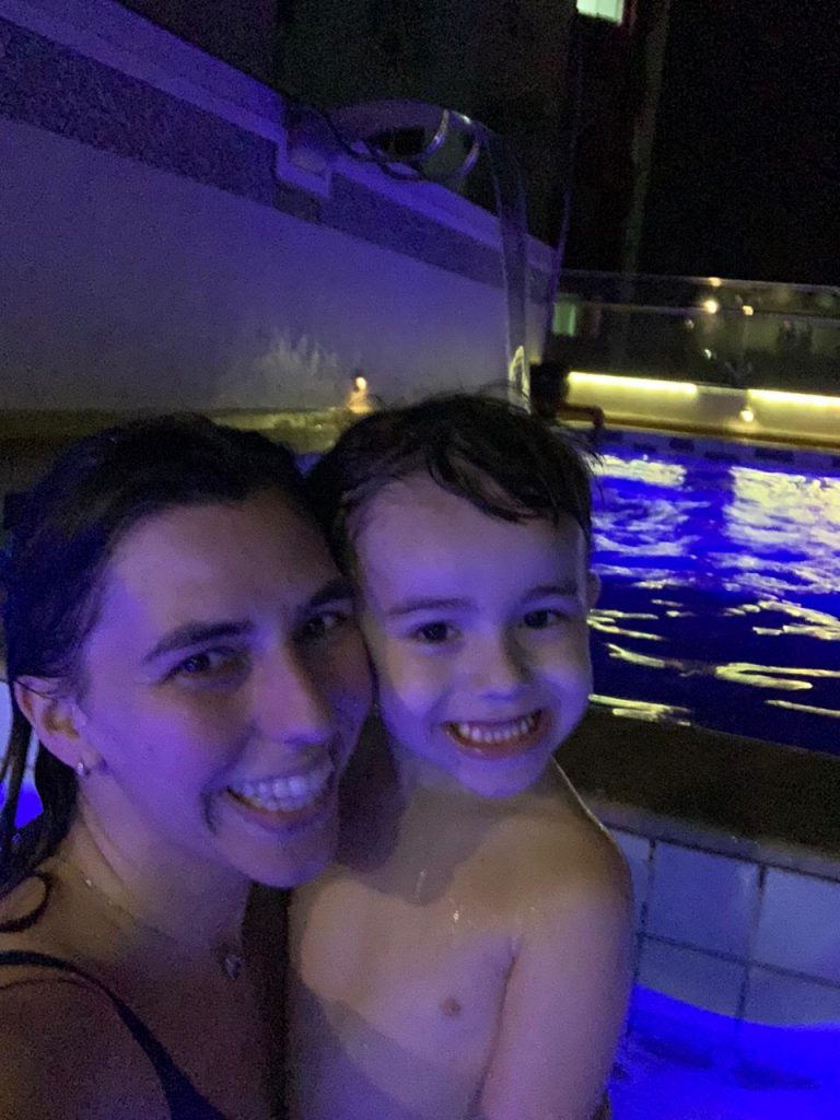 mãe e filho criança sorrindo a noite na piscina