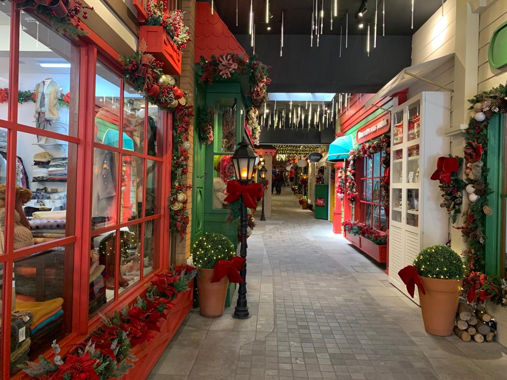 galeria comercial com decoração de natal com janela em vermelho em primeiro plano