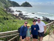 familia em mirante com vista para mar e pedras
