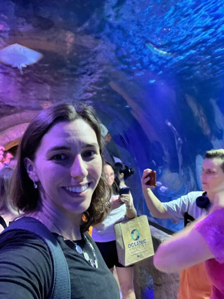 mulher em frente a túnel de aquário