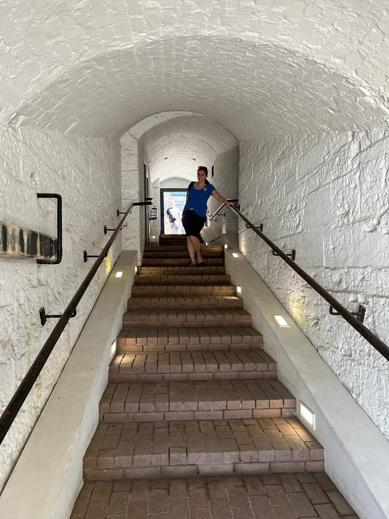 mulher em escadaria dentro de túnel